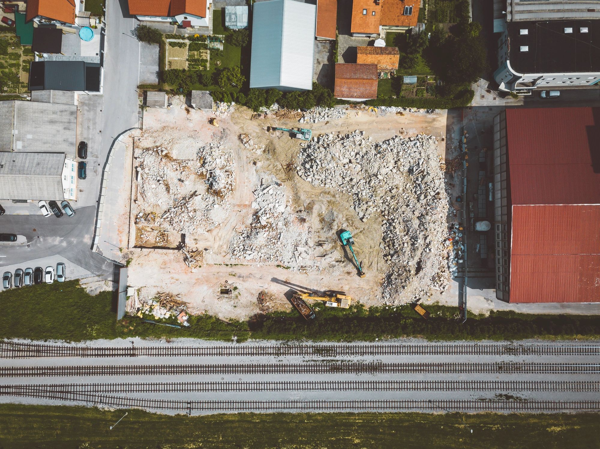 Aerial view of a construction site with equipment preparing a cleared lot